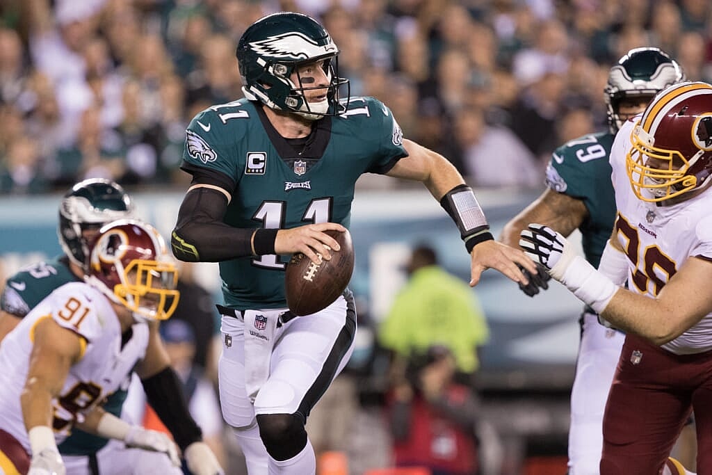 NFL Philadelphia Eagles quarterback Carson Wentz (11) runs out of the pocket past Washington Redskins defensive tackle Matthew Ioannidis (98) during the first quarter at Lincoln Financial Field.