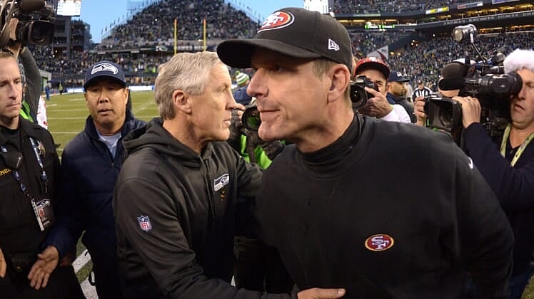 seattle seahawks hire jim harbaugh