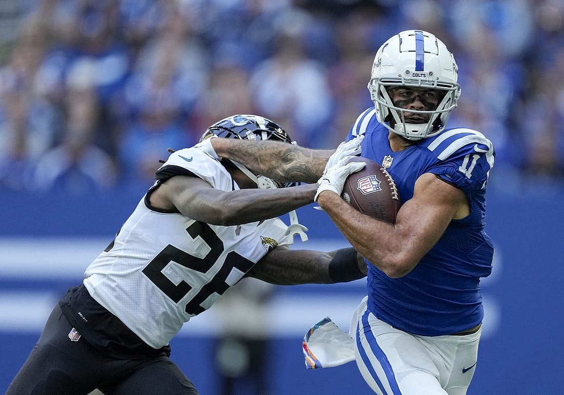 Oct 16, 2022; Indianapolis, Indiana, USA; Indianapolis Colts wide receiver Michael Pittman Jr. (11) pushes off of Jacksonville Jaguars cornerback Shaquill Griffin (26) as he runs with the ball during the first half at Lucas Oil Stadium. Mandatory Credit: Robert Scheer-USA TODAY Sports