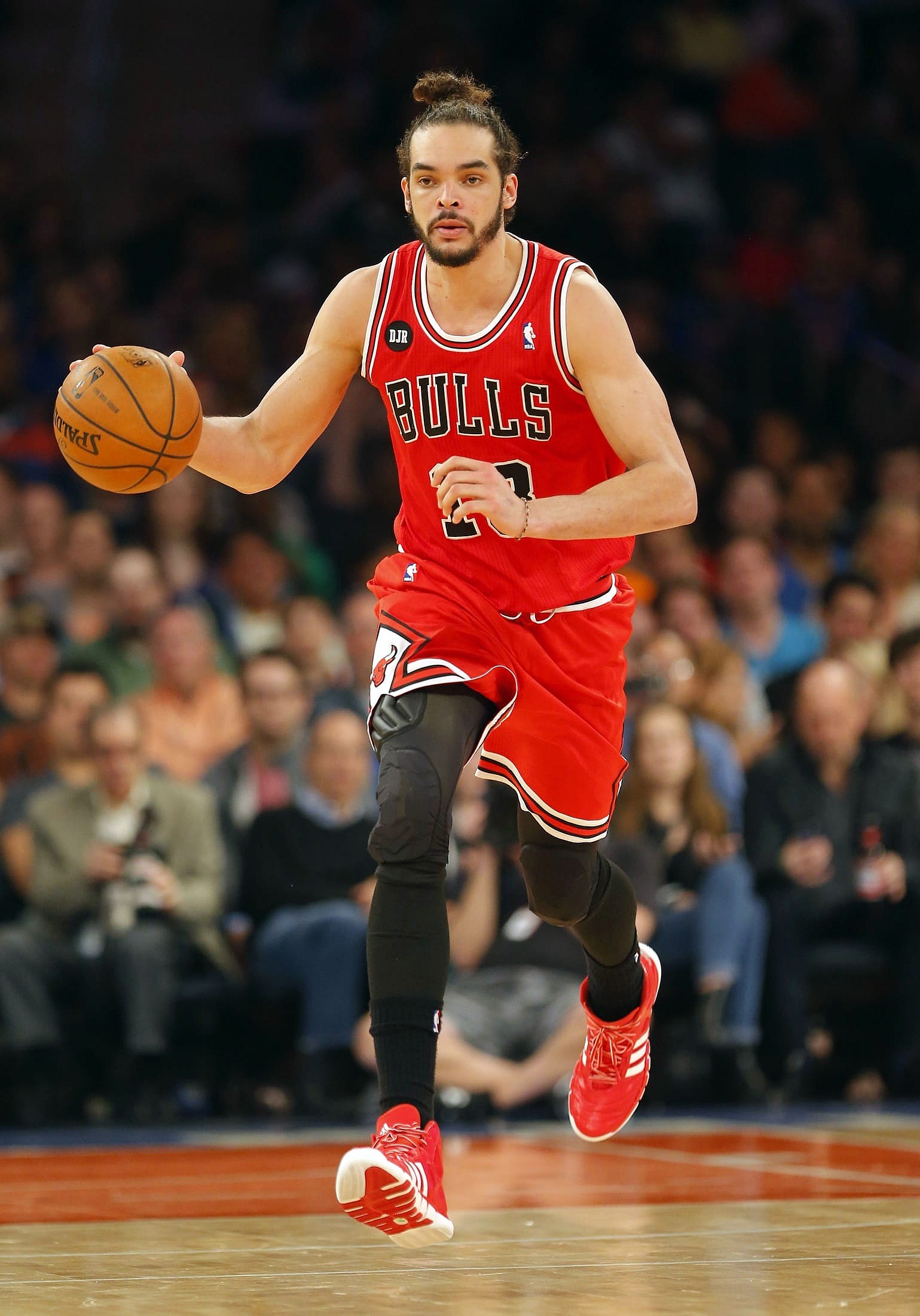 Joakim Noah examines the floor. Photo via Jim O'Connor, USA Today Sports Images