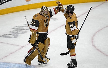 Vegas Golden Knights goaltender Adin Hill (33) and defenseman Nicolas Hague (14) celebrate after Game 2 of the NHL hockey Stanley Cup Finals against the Florida Panthers, Monday, June 5, 2023, in Las Vegas. The Golden Knights defeated the Panthers 7-2 to take a 2-0 series lead. (AP Photo/Abbie Parr)