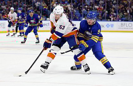 Mar 14, 2024; Buffalo, New York, USA;  New York Islanders center Casey Cizikas (53) controls the puck as Buffalo Sabres left wing Zach Benson (9) defends during the second period at KeyBank Center. Mandatory Credit: Timothy T. Ludwig-USA TODAY Sports