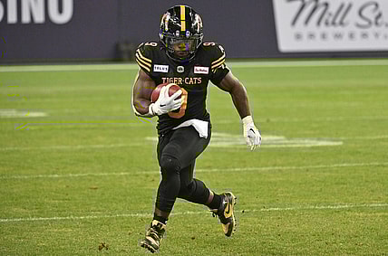 Jun 18, 2023; Toronto, Ontario, CAN;  Hamilton Tiger-Cats running back James Butler (9) runs with the ball against the Toronto Argonauts in the fourth quarter at BMO Field. Mandatory Credit: Dan Hamilton-USA TODAY Sports