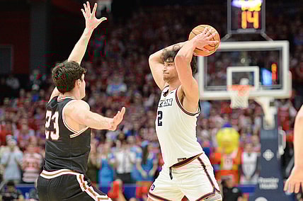 Feb 27, 2024; Dayton, Ohio, USA;  Dayton Flyers forward Nate Santos (2) passes the ball against Davidson Wildcats guard Connor Kochera (23) during the second half of the game at University of Dayton Arena. Mandatory Credit: Matt Lunsford-USA TODAY Sports