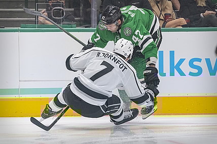 Oct 22, 2021; Dallas, Texas, USA; Dallas Stars right wing Alexander Radulov (47) and Los Angeles Kings defenseman Tobias Bjornfot (7) chase the puck during the second period at the American Airlines Center. Mandatory Credit: Jerome Miron-USA TODAY Sports
