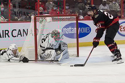 Nov 11, 2021; Ottawa, Ontario, CAN; Ottawa Senators left wing Nick Paul (21) steals the puck away from Los Angeles Kings goalie Jonathan Quick (32) as defenseman Mikey Anderson (44) defends in the second period at the Canadian Tire Centre. Mandatory Credit: Marc DesRosiers-USA TODAY Sports