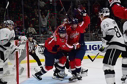 Nov 17, 2021; Los Angeles, California, USA; Washington Capitals right wing Garnet Hathaway (21) celebrates with right wing Daniel Sprong (10) his goal scored against the Los Angeles Kings during the third period at Staples Center. Mandatory Credit: Gary A. Vasquez-USA TODAY Sports