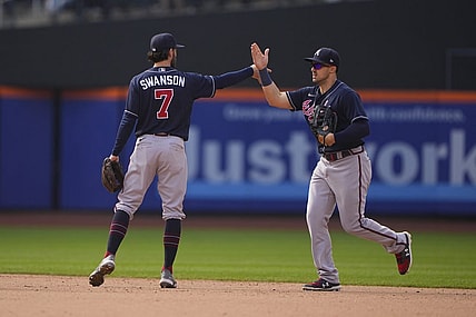 May 4, 2022; New York City, New York, USA; Atlanta Braves shortstop Dansby Swanson (7) and Atlanta Braves center fielder Adam Duvall (14) hi five to celebrate the victory after the ninth inning against the New York Mets at Citi Field. Mandatory Credit: Gregory Fisher-USA TODAY Sports
