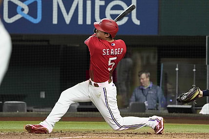 Jul 8, 2022; Arlington, Texas, USA; Texas Rangers shortstop Corey Seager (5) hits a three run home run against the Minnesota Twins during the fifth inning at Globe Life Field. Mandatory Credit: Jim Cowsert-USA TODAY Sports