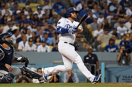 Aug 10, 2022; Los Angeles, California, USA; Los Angeles Dodgers third baseman Max Muncy (13) hits a solo home run in the second inning against the Minnesota Twins at Dodger Stadium. Mandatory Credit: Richard Mackson-USA TODAY Sports