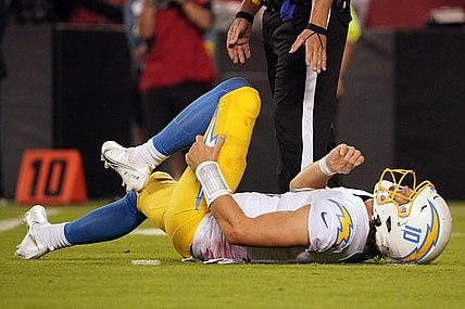 Sep 15, 2022; Kansas City, Missouri, USA; Los Angeles Chargers quarterback Justin Herbert (10) reacts after being hit by Kansas City Chiefs defensive end Mike Danna (51) during the second half at GEHA Field at Arrowhead Stadium. Mandatory Credit: Denny Medley-USA TODAY Sports