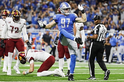 Sep 18, 2022; Detroit, Michigan, USA; Detroit Lions defensive end Aidan Hutchinson (97) celebrates a sack against Washington Commanders quarterback Carson Wentz (11) during the first half at Ford Field. Mandatory Credit: Junfu Han-USA TODAY Sports