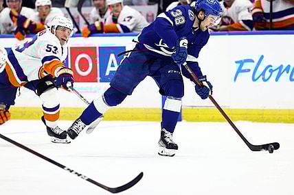 Oct 22, 2022; Tampa, Florida, USA; Tampa Bay Lightning left wing Brandon Hagel (38) skates with the puck against New York Islanders center Casey Cizikas (53) during the third period at Amalie Arena. Mandatory Credit: Kim Klement-USA TODAY Sports