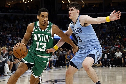 Nov 7, 2022; Memphis, Tennessee, USA; Boston Celtics guard Malcolm Brogdon (13) dribbles as Memphis Grizzlies forward Jake LaRavia (3) defends during the second half at FedExForum. Mandatory Credit: Petre Thomas-USA TODAY Sports