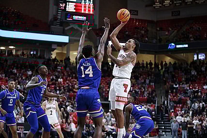 Nov 14, 2022; Lubbock, Texas, USA; Texas Tech Red Raiders guard Jaylon Tyson (20) shoots over Louisiana Tech Bulldogs forward Will Allen (14) in the first half at United Supermarkets Arena. Mandatory Credit: Michael C. Johnson-USA TODAY Sports