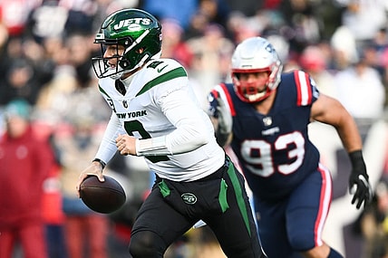 Nov 20, 2022; Foxborough, Massachusetts, USA; New York Jets quarterback Zach Wilson (2) runs under pressure from New England Patriots defensive end Lawrence Guy (93) during the first half at Gillette Stadium. Mandatory Credit: Brian Fluharty-USA TODAY Sports