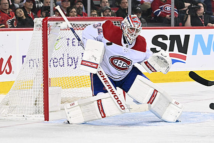 Dec 1, 2022; Calgary, Alberta, CAN; Montreal Canadiens  goalie Jake Allen (34) stops a shot from the Calgary Flames in the second period at Scotiabank Saddledome. Mandatory Credit: Candice Ward-USA TODAY Sports