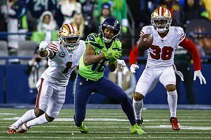 Dec 15, 2022; Seattle, Washington, USA; Seattle Seahawks wide receiver Tyler Lockett (16) drops a pass before being hit by San Francisco 49ers cornerback Jimmie Ward (1) during the fourth quarter at Lumen Field. Mandatory Credit: Joe Nicholson-USA TODAY Sports