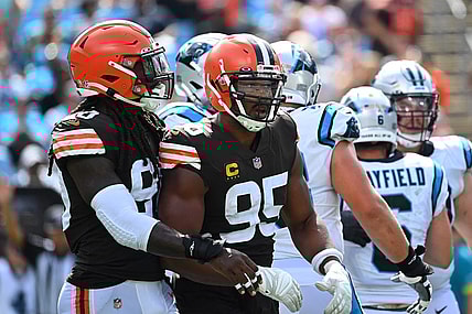 Sep 11, 2022; Charlotte, North Carolina, USA; Cleveland Browns defensive end Myles Garrett (95) reacts with defensive end Jadeveon Clowney (90) after sacking Carolina Panthers quarterback Baker Mayfield (6) in the third quarter at Bank of America Stadium. Mandatory Credit: Bob Donnan-USA TODAY Sports