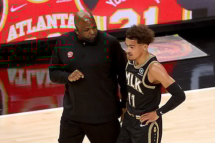 May 5, 2021; Atlanta, Georgia, USA; Atlanta Hawks coach Nate McMillan talks with guard Trae Young (11) during a time out of their game against the Phoenix Suns at State Farm Arena. Mandatory Credit: Jason Getz-USA TODAY Sports