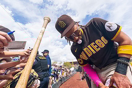 Mar 16, 2023; Salt River Pima-Maricopa, Arizona, USA; San Diego Padres outfielder Fernando Tatis Jr. (23) blows a bubblegum bubble as he signs autographs for fans before the start of the first inning for a spring training game against the Colorado Rockies at Salt River Fields at Talking Stick. Mandatory Credit: Allan Henry-USA TODAY Sports
