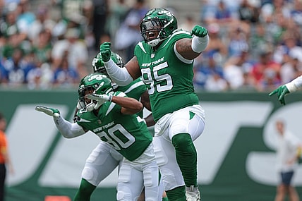 Aug 28, 2022; East Rutherford, New Jersey, USA; New York Jets defensive tackle Quinnen Williams (95) celebrates his sack with cornerback Michael Carter II (30) during the first half against the New York Giants at MetLife Stadium. Mandatory Credit: Vincent Carchietta-USA TODAY Sports