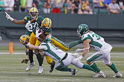 Jun 11, 2023; Edmonton, Alberta, CAN; Saskatchewan Roughriders defensive back Jaxon Ford (17) tackles Edmonton Elks running back Kevin Brown (4) during the second half at Commonwealth Stadium. Mandatory Credit: Perry Nelson-USA TODAY Sports