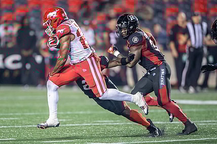 Jun 15, 2023; Ottawa, Ontario, CAN; Calgary Stampeders running back Dedrick Mills (26) runs the ball in the second half against the Ottawa REDBLACKS at TD Place. Mandatory Credit: Marc DesRosiers-USA TODAY Sports
