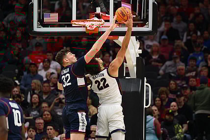 Dec 15, 2023; Seattle, Washington, USA; Connecticut Huskies center Donovan Clingan (32) blocks a shot attempt by Gonzaga Bulldogs forward Anton Watson (22) during the second half at Climate Pledge Arena. Mandatory Credit: Steven Bisig-USA TODAY Sports