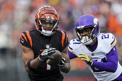 Dec 16, 2023; Cincinnati, Ohio, USA; Cincinnati Bengals wide receiver Ja'Marr Chase (1) runs with the ball against Minnesota Vikings cornerback Akayleb Evans (21) in the first half at Paycor Stadium. Mandatory Credit: Katie Stratman-USA TODAY Sports