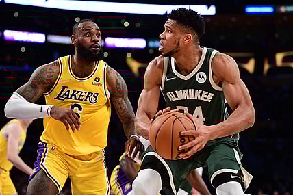 Feb 8, 2022; Los Angeles, California, USA; Milwaukee Bucks forward Giannis Antetokounmpo (34) moves the ball against Los Angeles Lakers forward LeBron James (6) during the second half at Crypto.com Arena. Mandatory Credit: Gary A. Vasquez-USA TODAY Sports