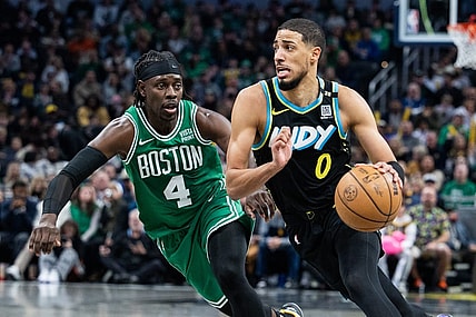 Jan 6, 2024; Indianapolis, Indiana, USA; Indiana Pacers guard Tyrese Haliburton (0) dribbles the ball against Boston Celtics guard Jrue Holiday (4) in the second half at Gainbridge Fieldhouse. Mandatory Credit: Trevor Ruszkowski-USA TODAY Sports