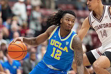 Feb 7, 2024; Stanford, California, USA;  UCLA Bruins guard Sebastian Mack (12) controls the ball during the second half against Stanford Cardinal forward Spencer Jones (14) at Maples Pavilion. Mandatory Credit: Stan Szeto-USA TODAY Sports