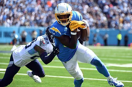 Sep 17, 2023; Nashville, Tennessee, USA; Los Angeles Chargers wide receiver Mike Williams (81) runs after a catch against Tennessee Titans cornerback Tre Avery (23) during the first half at Nissan Stadium. Mandatory Credit: Christopher Hanewinckel-USA TODAY Sports