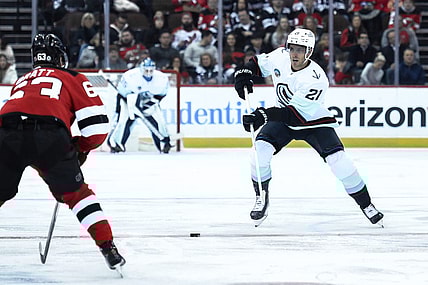 Feb 12, 2024; Newark, New Jersey, USA; Seattle Kraken center Alex Wennberg (21) skates with the puck against as New Jersey Devils left wing Jesper Bratt (63) defends during the first period at Prudential Center. Mandatory Credit: John Jones-USA TODAY Sports