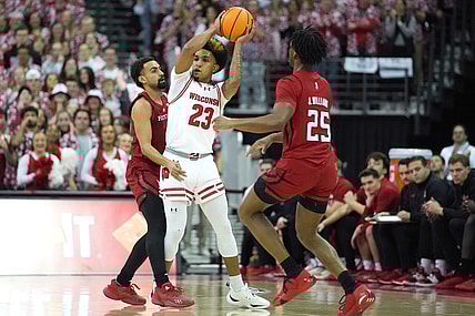 Mar 7, 2024; Madison, Wisconsin, USA;  Wisconsin Badgers guard Chucky Hepburn (23) looks to pass the ball against Rutgers Scarlet Knights guard Noah Fernandes (2) and Rutgers Scarlet Knights guard Jeremiah Williams (25) during the first half at Kohl Center. Mandatory Credit: Kayla Wolf-USA TODAY Sports