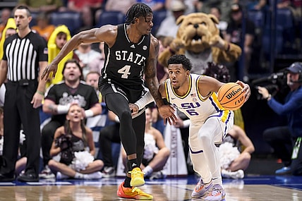 Mar 14, 2024; Nashville, TN, USA; LSU Tigers guard Jordan Wright (6) dribbles as Mississippi State Bulldogs forward Cameron Matthews (4) guards during the first half at Bridgestone Arena. Mandatory Credit: Steve Roberts-USA TODAY Sports