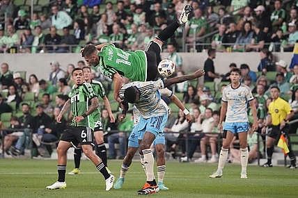 Mar 16, 2024; Austin, Texas, USA; Austin FC forward Diego Rubio (14) and Philadelphia Union defender Damion Lowe (17) collide in the first half at Q2 Stadium. Mandatory Credit: Scott Wachter-USA TODAY Sports