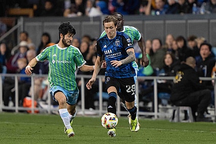 Mar 23, 2024; San Jose, California, USA; San Jose Earthquakes forward Benji Kikanovic (28) dribbles the ball while Seattle Sounders FC midfielder Dylan Teves (99) defends during the second half at PayPal Park. Mandatory Credit: Stan Szeto-USA TODAY Sports