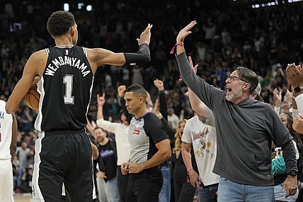 Mar 29, 2024; San Antonio, Texas, USA; San Antonio Spurs forward Victor Wembanyama (1) and a fan react after an overtime victory over the New York Knicks at Frost Bank Center. Mandatory Credit: Scott Wachter-USA TODAY Sports