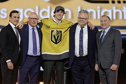 Trevor Connelly, center, poses after being selected by the Vegas Golden Knights during the first round of the NHL hockey draft Friday, June 28, 2024, in Las Vegas. (AP Photo/Steve Marcus)