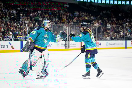 New York Sirens goalie Kayle Osborne fist bumps rookie forward Casey O'Brien.