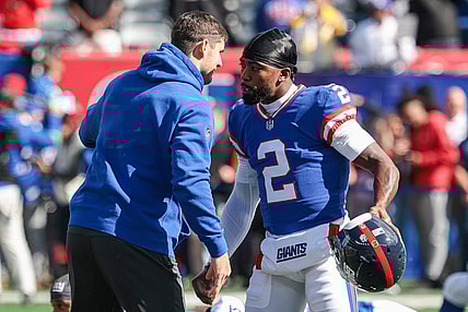 Oct 22, 2023; East Rutherford, New Jersey, USA; New York Giants quarterback Daniel Jones (left) talks with quarterback Tyrod Taylor (2) before the game against the Washington Commanders at MetLife Stadium. Mandatory Credit: Vincent Carchietta-USA TODAY Sports