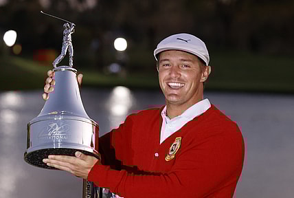 Mar 7, 2021; Orlando, Florida, USA; Bryson DeChambeau holds the champions trophy after winning the Arnold Palmer Invitational golf tournament at Bay Hill Club & Lodge. Mandatory Credit: Reinhold Matay-USA TODAY Sports