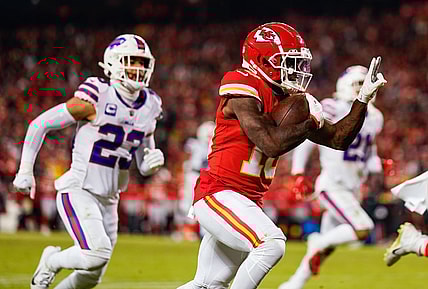 Jan 23, 2022; Kansas City, Missouri, USA; Kansas City Chiefs wide receiver Tyreek Hill (10) runs the ball for a touchdown past Buffalo Bills safety Micah Hyde (23) during the second half in a AFC Divisional playoff football game at GEHA Field at Arrowhead Stadium. Mandatory Credit: Jay Biggerstaff-USA TODAY Sports
