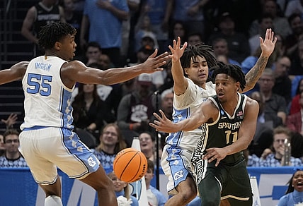 March 23, 2024, Charlotte, NC, USA; Michigan State Spartans guard A.J. Hoggard (11) passes away from North Carolina Tar Heels forward Harrison Ingram (55) and North Carolina Tar Heels guard Elliot Cadeau (2)  in the second round of the 2024 NCAA Tournament at the Spectrum Center. Mandatory Credit: Bob Donnan-USA TODAY Sports