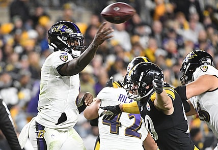 Dec 5, 2021; Pittsburgh, Pennsylvania, USA;  Baltimore Ravens quarterback Lamar Jackson (8) is pressured by linebacker T.J. Watt (90) during the second quarter at Heinz Field. Mandatory Credit: Philip G. Pavely-USA TODAY Sports