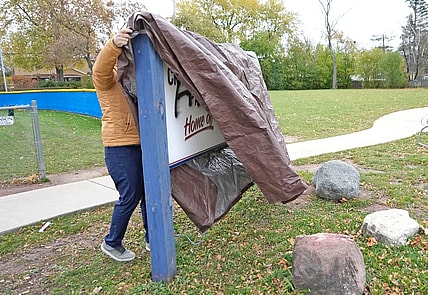 A man who wished to remain unidentified covers up a sign outside Craig Counsell Park on North Lydell Avenue that was vandalized in the last day with spray paint in Whitefish Bay on Tuesday, Nov. 7, 2023. Counsell signed a record-breaking contract to manage the Chicago Cubs.