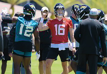 Jaguars quarterback Trevor Lawrence (16) talks with teammates during drills at rookie minicamp.Jki 051521 Jaguarsrookiecamp 05