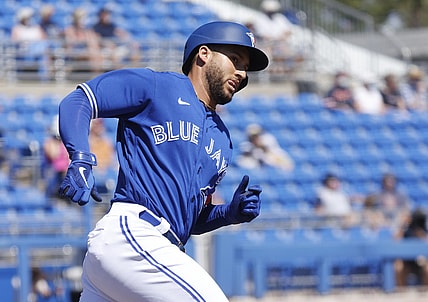 Mar 11, 2021; Dunedin, Florida, USA;  Toronto Blue Jays center fielder George Springer (4) hits a home run during the first inning against the Detroit Tigers during spring training at TD Ballpark. Mandatory Credit: Kim Klement-USA TODAY Sports